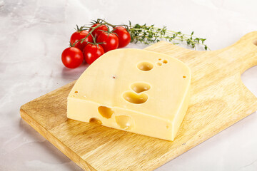 Maasdam cheese brick over board