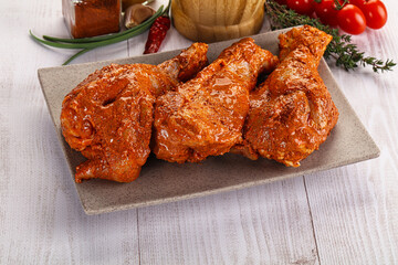 Raw turkey shoulder wing in Indian tandoori marinade