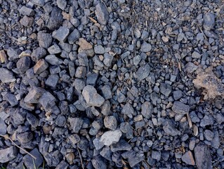 Texture of black stone coal poured on a pile. Industry and coal mining. Natural resources and fossil minerals.