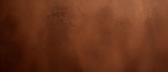 Fototapeta premium Close-up texture of reddish-brown surface with rugged and cracked patterns