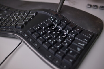 Clean keyboard with vacuum for office maintenance, improving hygiene and professionalism