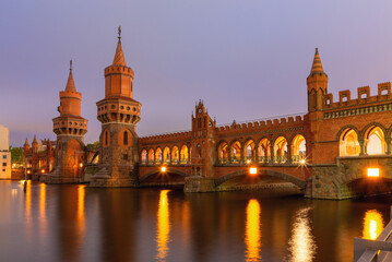 Old Berlin Oberbaum Bridge over the Spree River at sunset.