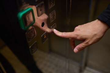 CloseUp of Hand Pressing Elevator Button Person Operating Modern Building Lift