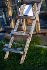 An old wooden staircase tilted onto the barn. Wooden stairs in the village.