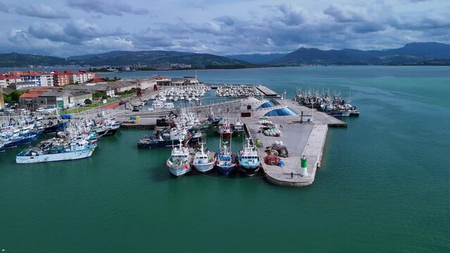 Fishing boats working in the port fishing village of Santo&ntilde;a in the Marismas de Santo&ntilde;a, Victoria and Joyel Natural Park. Cantabrian Sea. Santo&ntilde;a, Cantabria, Spain, Europe