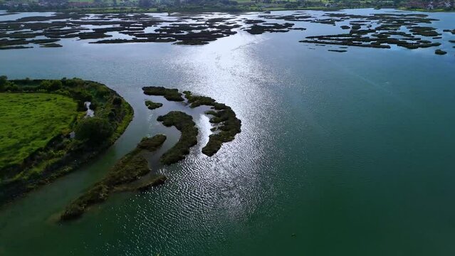 Aerial drone view of the marshes at low tide at sunset in Escalante in the Marismas de Santo&ntilde;a, Victoria y Joyel Natural Park. Cantabrian Sea. Santo&ntilde;a, Cantabria, Spain, Europe