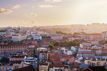 Naklejka premium View of Lisbon famous view from Miradouro da Senhora do Monte tourist viewpoint in contre-jou on sunset. Lisbon, Portugal