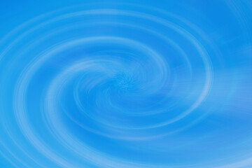 A vortex of sky blue color. Abstract background with scratched lines in a swirl pattern