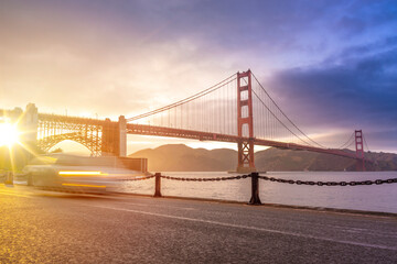 The light illuminated famous Golden Gate Bridge from the waterfront, San Francisco, USA
