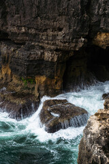 Boca do Inferno (Hell's Mouth) is a unique rock formation on the edge of the ocean in Cascais, Portugal. Cloudy day.