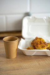 muffins in a lunch box and an eco cup