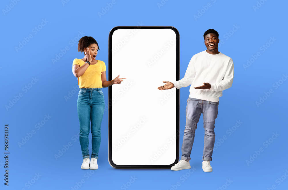 Poster a man and a woman are standing side by side, looking at a blank screen on a phone. the man is holdin