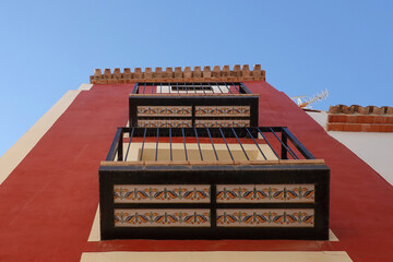 Naklejka premium Low angle view of traditional small balconies of old residential building in Villajoyosa, Spain