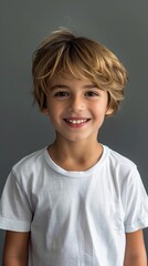 Smiling Boy in White T-shirt on Gray Background