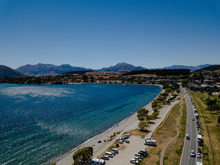Aerial view of a coastal town with clear blue water