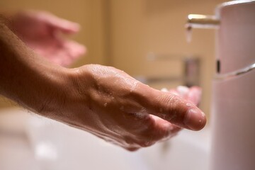 An automatic hand soap dispenser creates foam, promoting hygiene and cleanliness