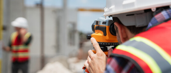 Civil or construction engineer using a survey camera, or an engineer with an auto level camera.