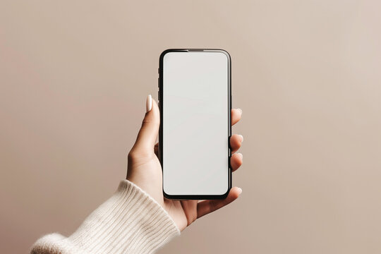 Phone mockup in the woman's hand with beige background