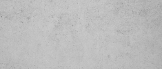 Close-up image of a textured concrete wall, highlighting the rough surface and details in monochrome..