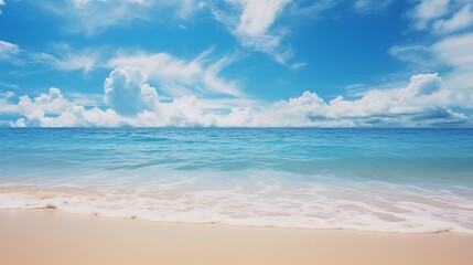Obraz premium Serene Beach Landscape with Blue Sky and Gentle Waves Meeting Sandy Shore