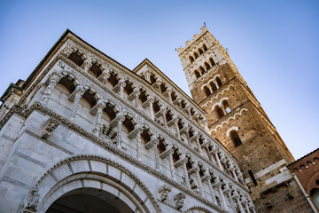Obraz premium Romanesque Facade and bell tower of St. Martin Cathedral in Lucca, Tuscany. It contains most precious relic in Lucca, Holy Face of Lucca (Italian: Volto Santo di Lucca)