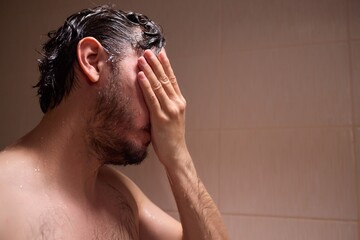 A man is taking a shower, enjoying the clean water to ensure good hygiene and relaxation