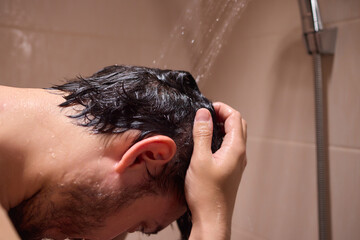 A man is taking a shower, enjoying the clean water to ensure good hygiene and relaxation