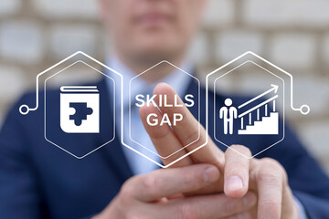 Business man working on virtual touch screen presses inscription: SKILLS GAP. Concept of Employee Skills Gap Analysis. Lack of Knowledge and Experience. Getting New Skills for Career Growth.