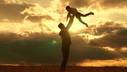 Concept, family safety trust, Dad plays with his daughter, throws child into sky with his hands,...