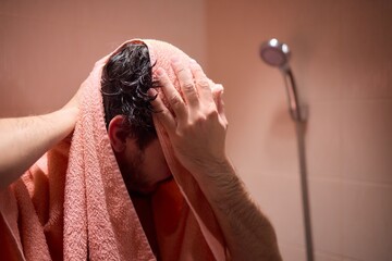Drying hair with a towel after showering is important for hygiene and selfcare in a shower routine