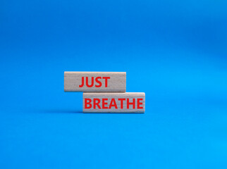 Just Breathe symbol. Wooden blocks with words Just Breathe. Beautiful blue background. Business and Just Breathe concept. Copy space.