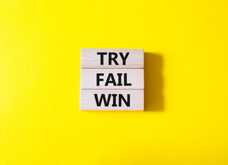 Try Fail Win symbol. Concept words Try Fail Win on wooden blocks. Beautiful yellow background....