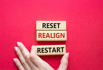 Reset Realign Restart symbol. Concept words Reset Realign Restart on wooden blocks. Businessman...