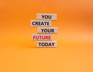 Future and development symbol. Wooden blocks with words You Create your Future today. Beautiful orange background. Business and Future and development concept. Copy space.