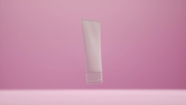 Plastic cosmetic white tube package for bb-cream, scrub, tonic, toothpaste, body care. Bottle on gently pink background slowly rotates in air for product design and advertising