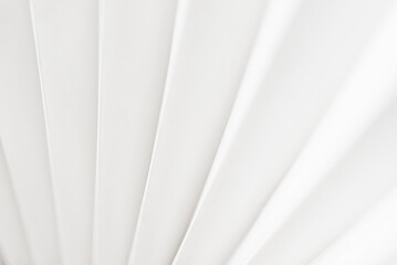 Obraz premium Minimalistic white dynamic background with diagonal lines, curtains, abstract dark geometric shape from fabrics with soft shadow background, top view 