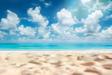 Fototapeta premium Abstract blur defocused background. Tropical summer beach with golden sand, turquoise ocean and blue sky with white clouds on bright sunny day. Colorful landscape for summer holidays.