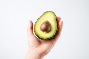 A hand holds a ripe avocado, showcasing its vibrant green color and creamy texture, perfect for adding richness to meals and snacks.