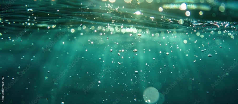 Wall mural Bubbles and bokeh underwater in clear green ocean.