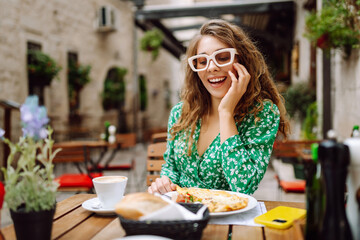 Woman eating italian pasta and drinking coffee at restaurant on the street in Rome. Concept of Italian gastronomy and travel. Tourism, food and drink.