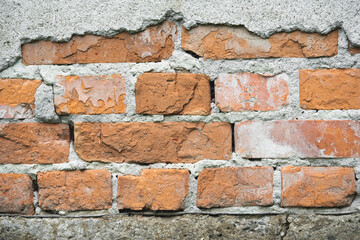 texture of old cracked brick wall and peeling plaster