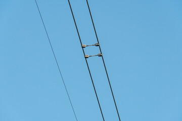 Power lines and high-voltage wires against a background of blue sky and fluffy clouds. Energy...