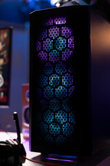 RGB lights illuminated fans on gaming computer capable of playing latest games, close up shot,...