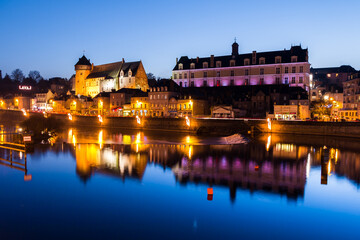 Scenic view of the historic laval town and castle reflected on the calm river at dusk