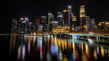 Singapore skyline at night with vibrant reflections