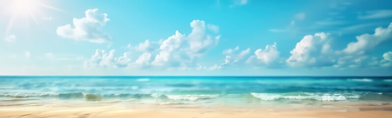 Fototapeta premium Abstract blur defocused background. Tropical summer beach with golden sand, turquoise ocean and blue sky with white clouds on bright sunny day