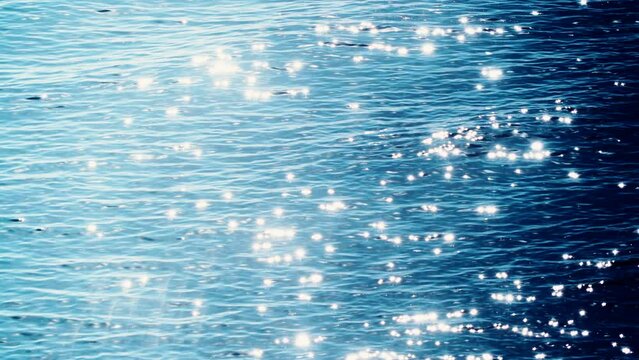 Sun reflecting and sparkling on blue sea water surface. Nature background