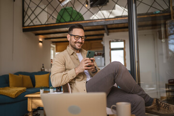 Adult man sit and use mobile phone for text message or surf at home