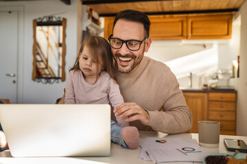 Adult man work from home with his two years old daughter at home