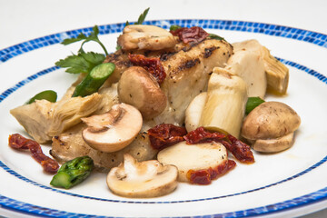 fried cod fillet with mushrooms, asparagus and potatoes ready to eat, close-up view